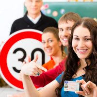 Driving school – driving instructor in his class and a female st
