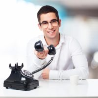smiling-man-talking-on-a-black-phone_1187-3122